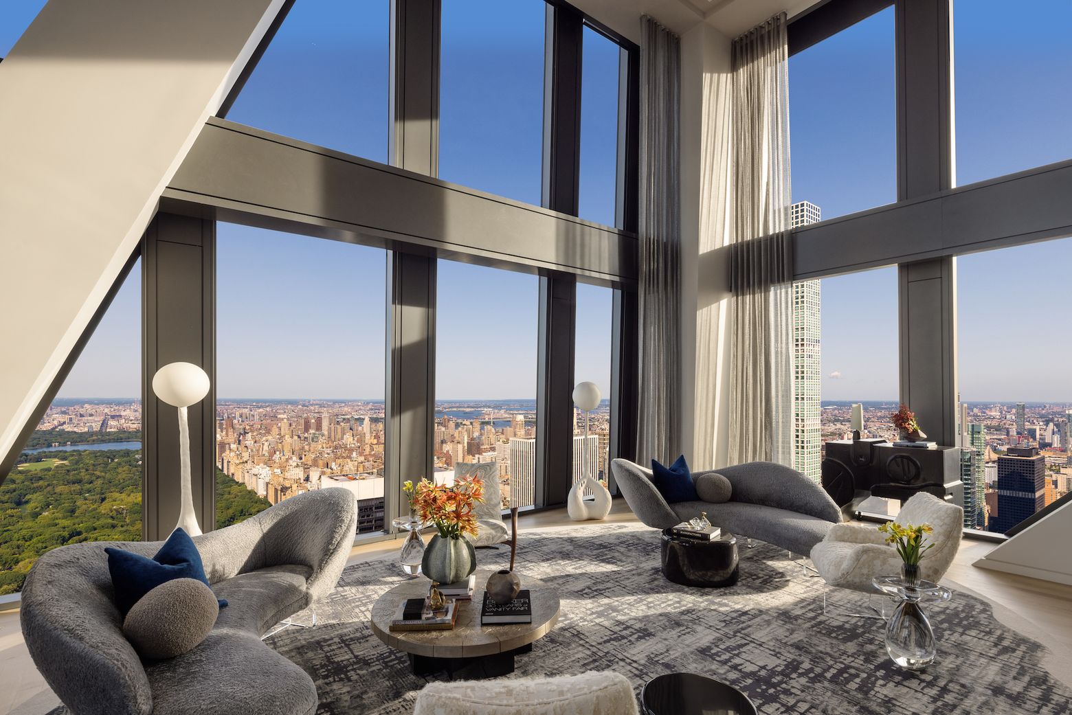 Double-height penthouse living room with skyline views
